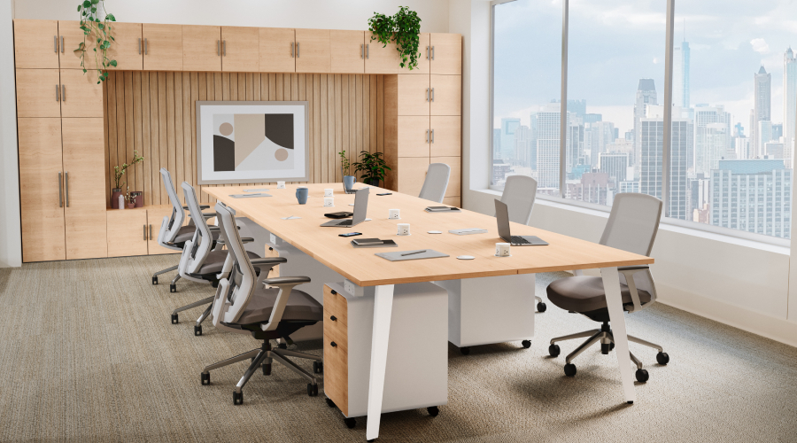 4-Person Table by UPLIFT Desk in an open-plan office with a black steel frame and laminate desktops.