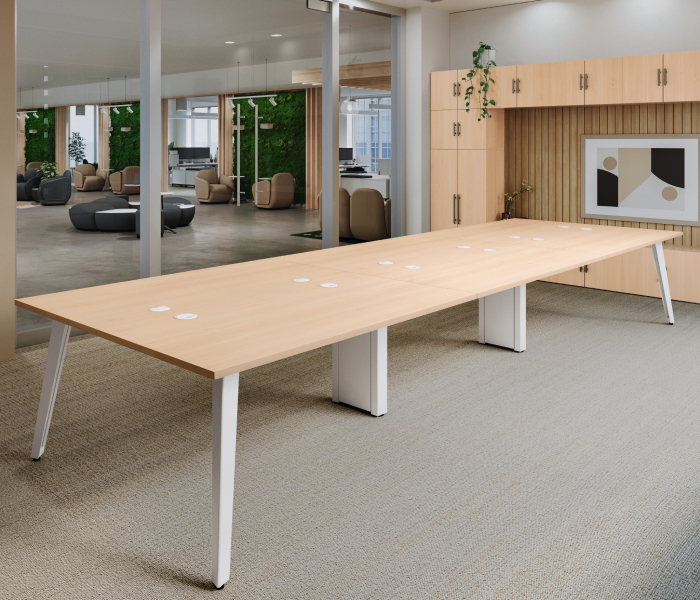 Close view of the 4-Person Table by UPLIFT Desk showing the center support leg and Pop Up Power Grommet.