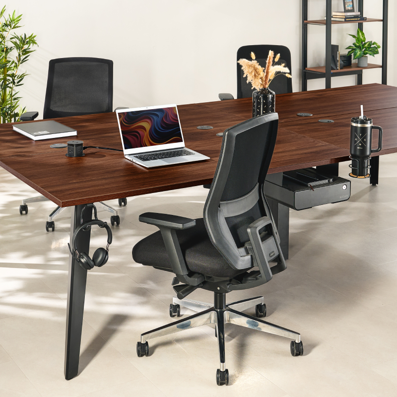 6-Person Table by UPLIFT Desk in an open-plan office with ergonomic chairs and matching storage.