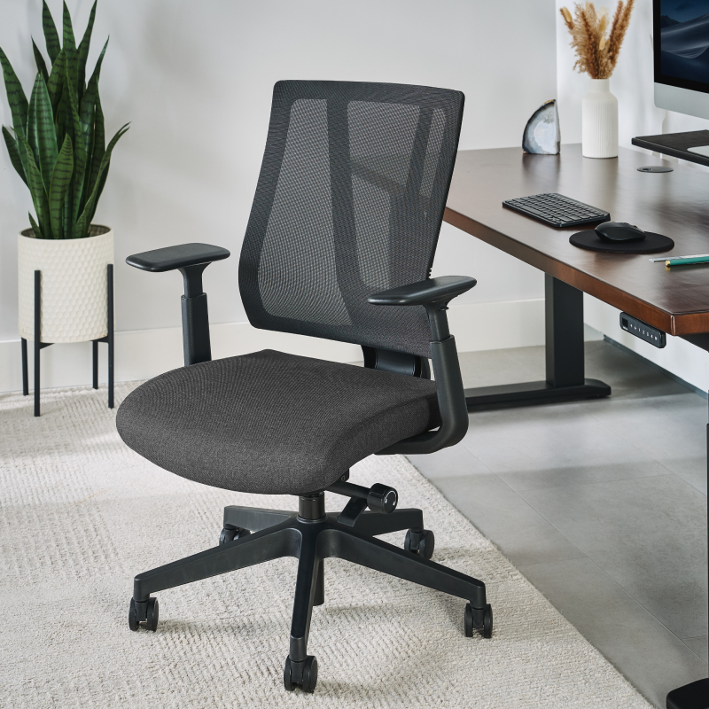 Clarksville Ergonomic Chair by UPLIFT Desk at a conference table.