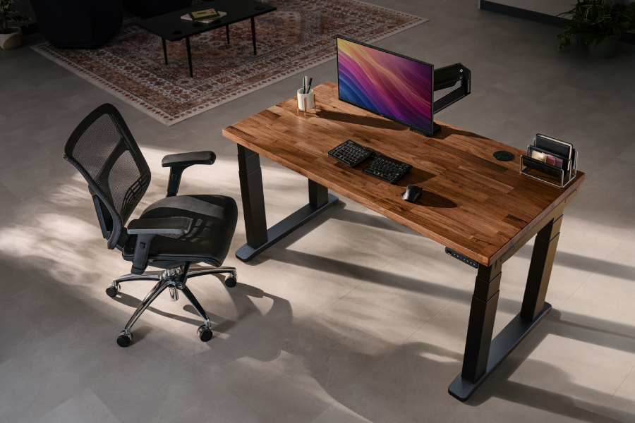 Isometric view of the UPLIFT 4-Leg Standing Desk showing all four lifting columns.