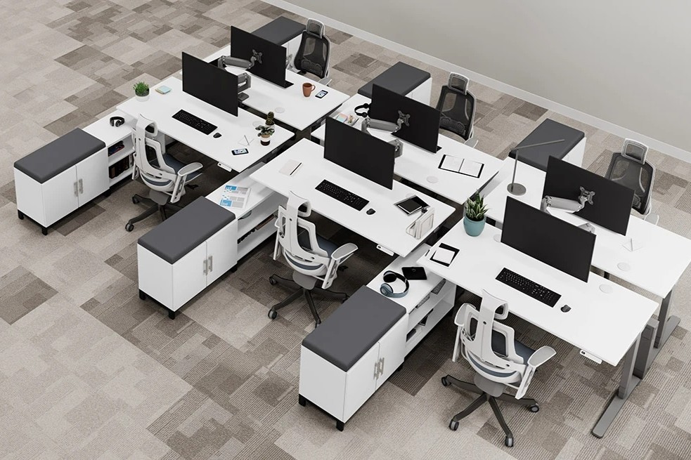 Top-down view of UPLIFT Desk standing desks and MoPac Credenzas in a shared office.