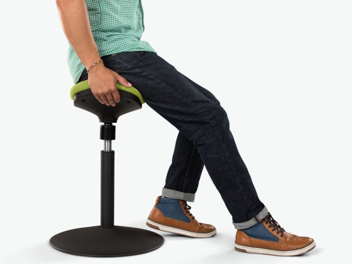 Ergonomic stool in a sit-stand workspace.