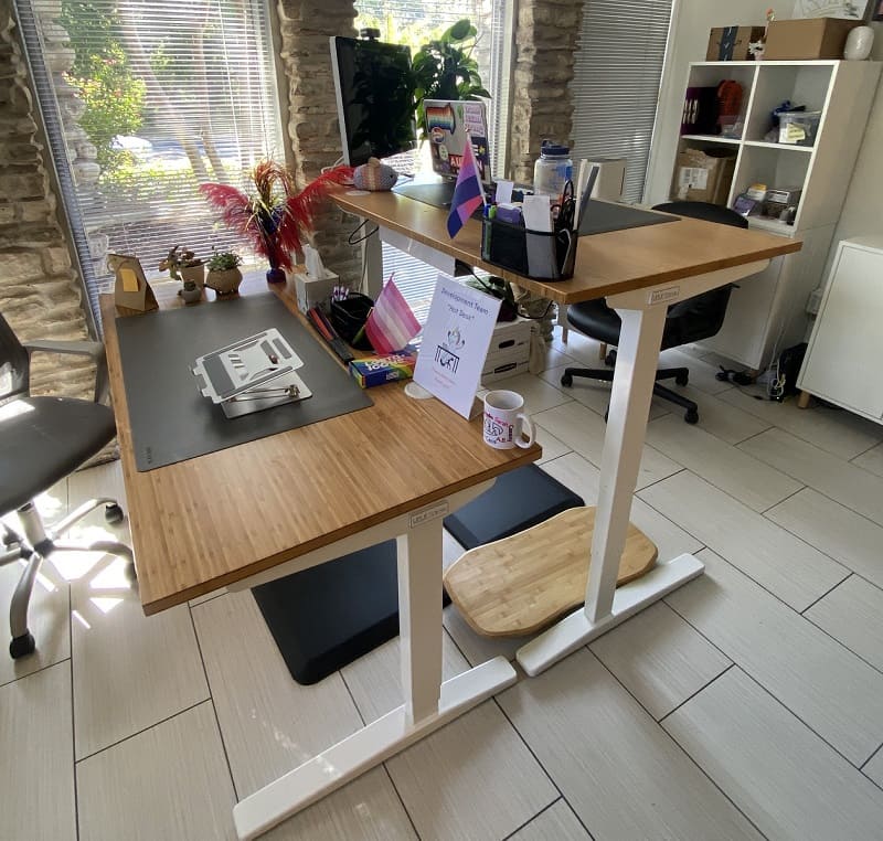 Two donated UPLIFT Standing Desks with standing mats and Rocker-X Motion Board in the Out Youth office