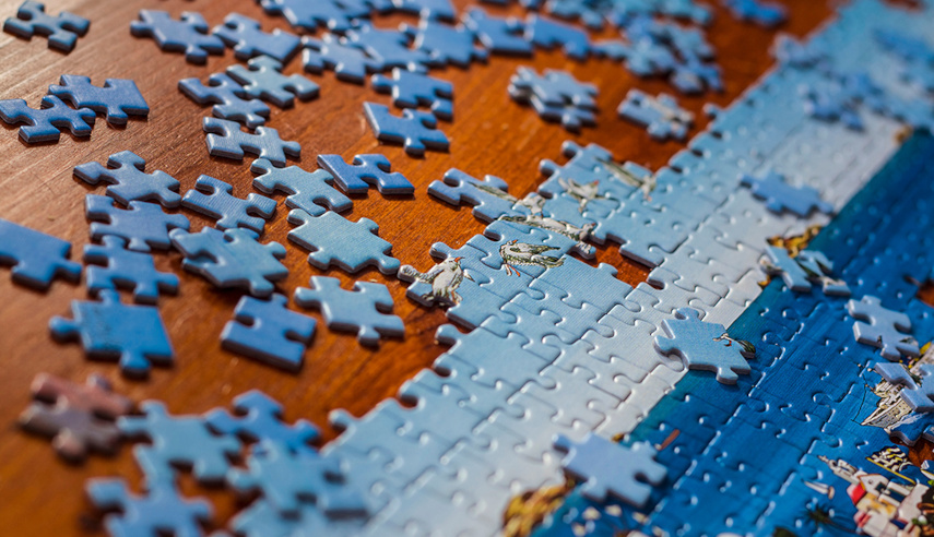 Incomplete puzzle on a standing desk.