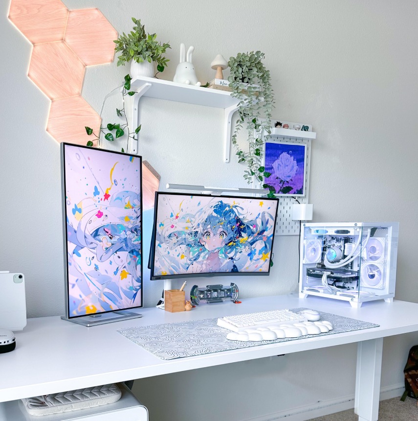 White laminate Uplift sit stand desk featuring a computer, monitors, and accessories.