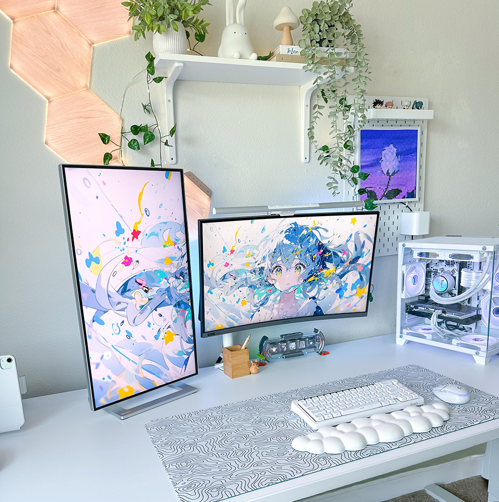 White laminate Uplift sit stand desk featuring a computer, monitors, and accessories.