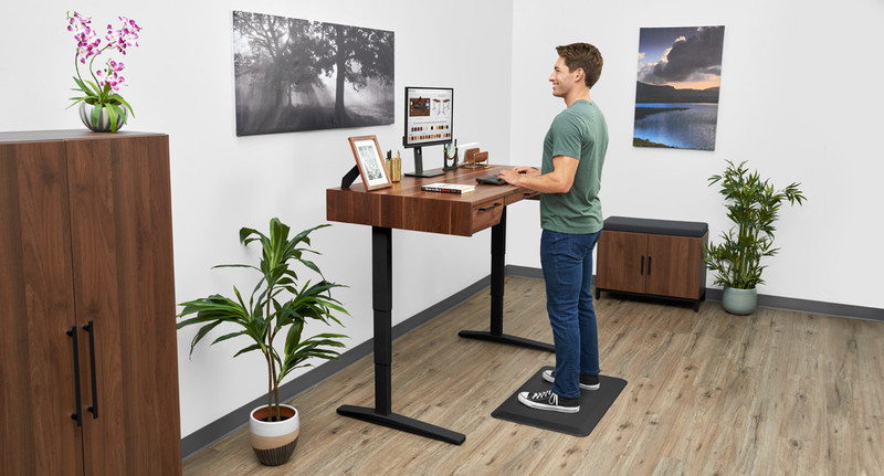 UPLIFT Solid Wood Standing Desk featuring Saman Butcher Block with various desk accessories.