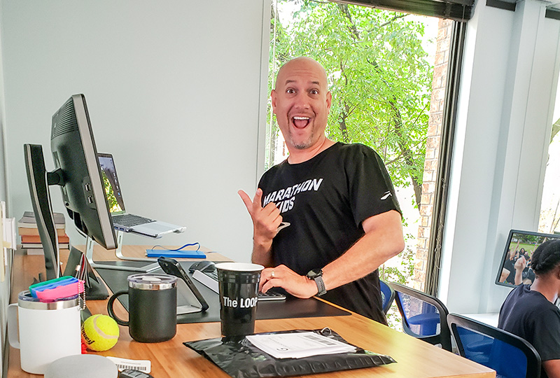 Marathon Kids team member working at their ergonomic workstation provided by UPLIFT Desk