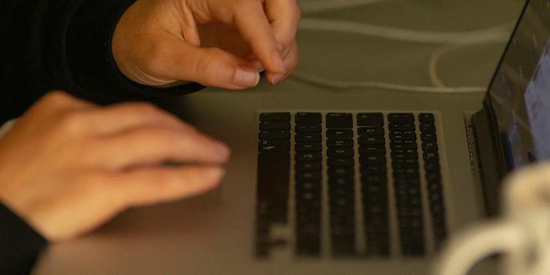 Handing resting on macbook laptop while typing