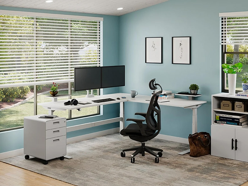 UPLIFT L-shaped standing desk in corner office setup