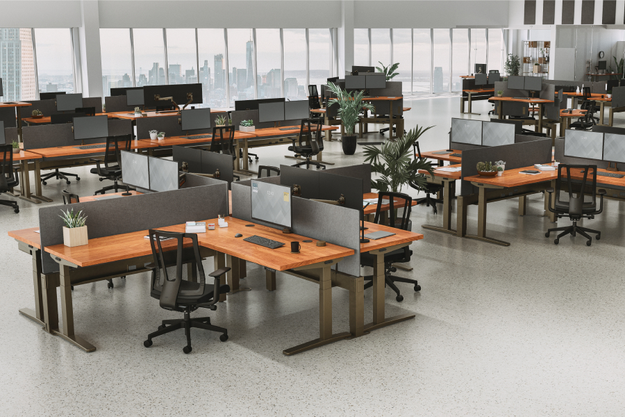 An office outfitted with multiple UPLIFT L-Shaped Standing Desks in a coordinated floor plan