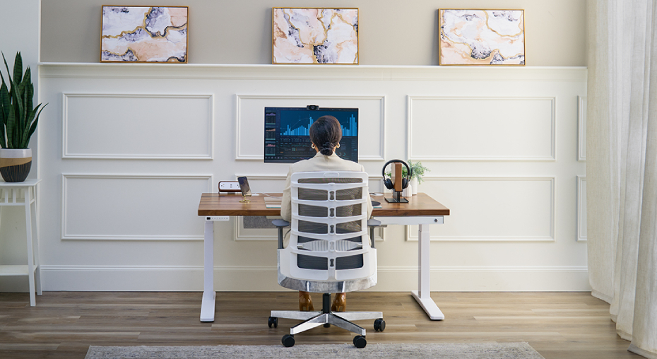A clean, ordered UPLIFT Desk workspace in white with minimal accessories on the desktop.