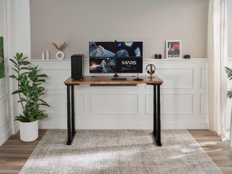 An UPLIFT Desk 4-leg standing desk in an home office