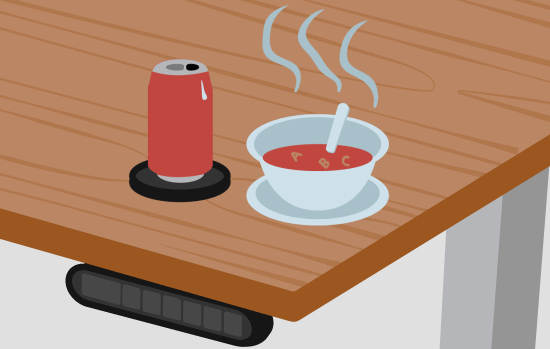 A soda can and hot bowl of soup on coasters to protect the desktop
