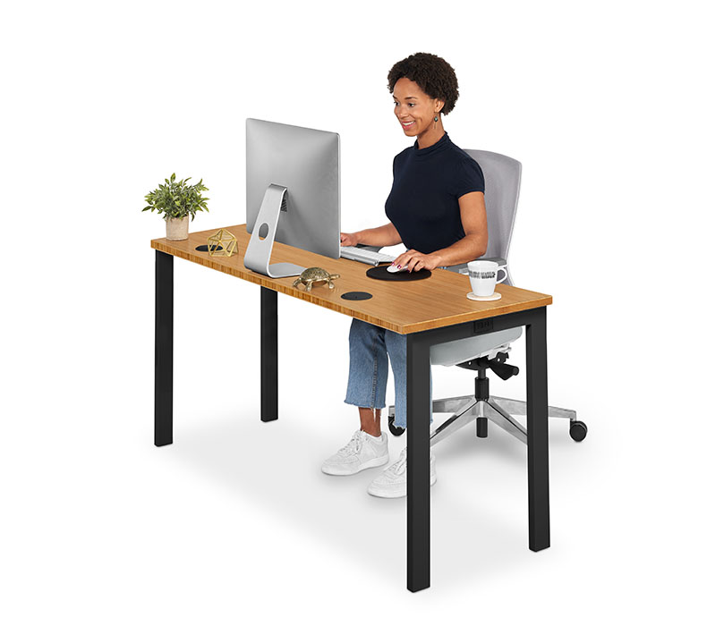 A person working at a Bamboo Seated Height 4-Leg office table for home or workplace