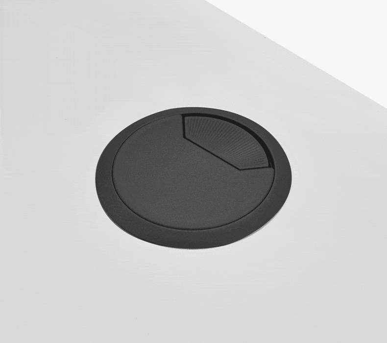 A GIF of cords running through a Grommet Cover on a stand up desk