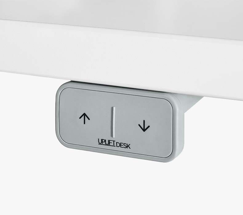 Close-up of a gray Basic Comfort Flush Keypad for making height adjustments on a sit-to-stand desk