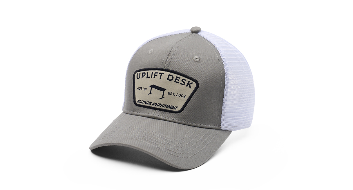 The mid-crown profile and mesh side and rear panels give a classic trucker feel to UPLIFT Desk Caps